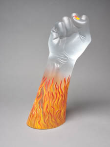 Translucent glass sculpture of a raised fist with red and orange flames around the arm