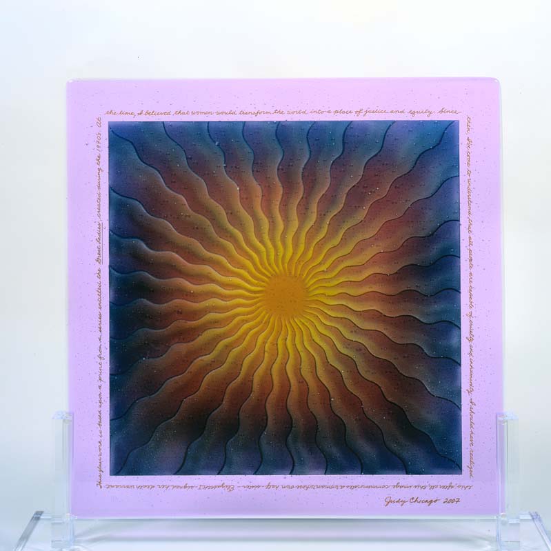 Sculpture of a painted pink rectangle with wavy lines radiating from a circular center in shades of yellow, red, blue, and pink on a clear plinth
