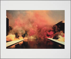 Print of a cloud of orange smoke over a rectangular pool with buildings on either side