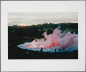 Print of a cloud of pink smoke rising from a black ground with two small figures standing next to it