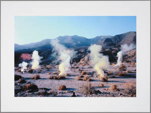 Print of several plumes of white smoke rising from a desert landscape
