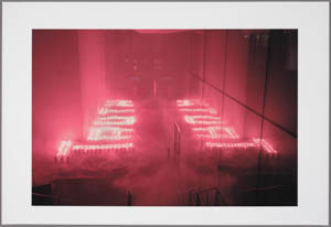 Print of the word truth spelled in red flares on the ground and reflected in a mirrored wall