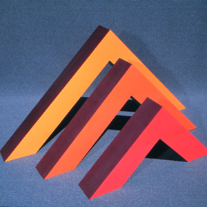 Three triangular shapes painted amber, orange and red
