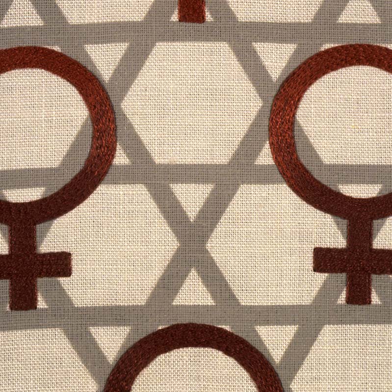 Detail of a textile work with dark red female symbols overlaid on a gray pattern of the Star of David