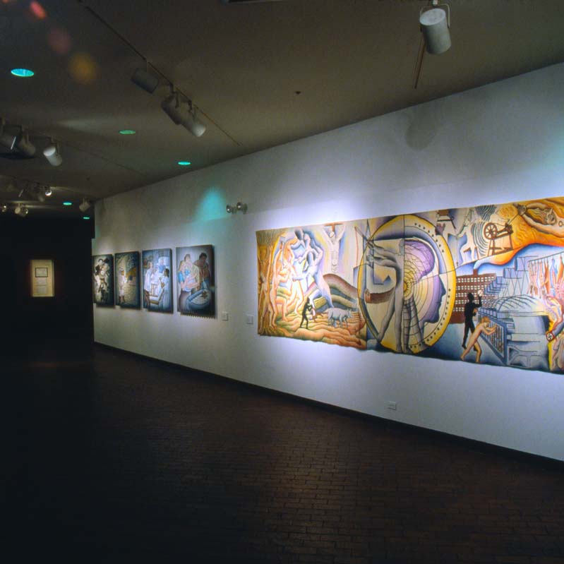 Color photograph of paintings installed on white walls in a gallery