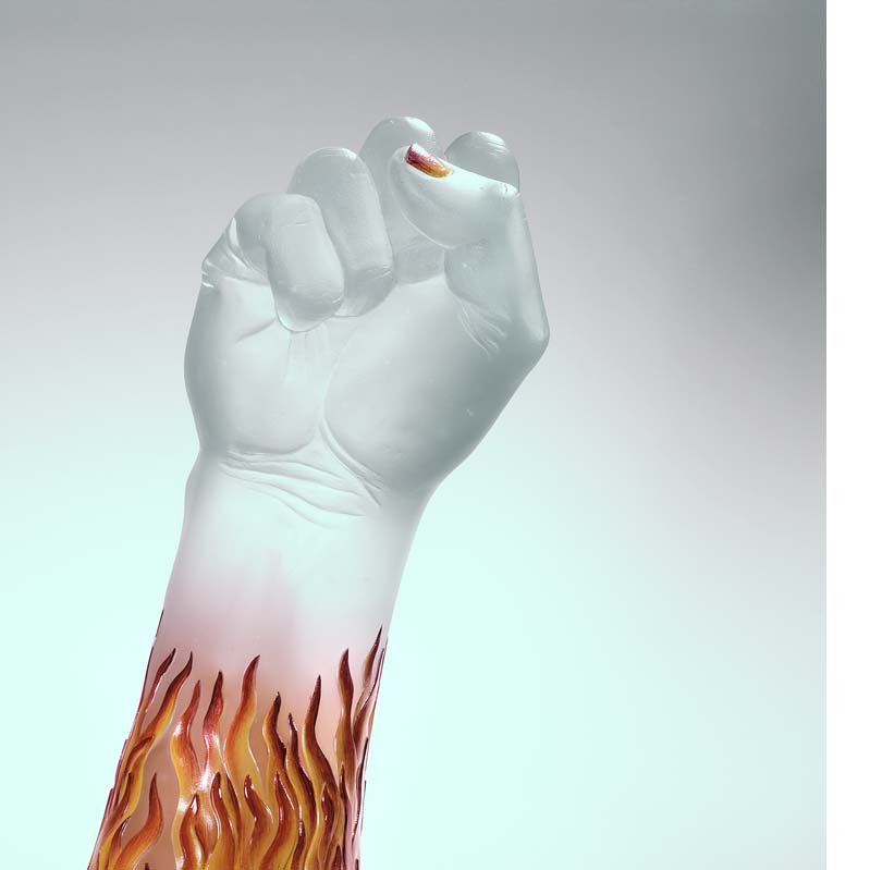 Sculpture of a translucent white raised fist with orange and red flames on the arm