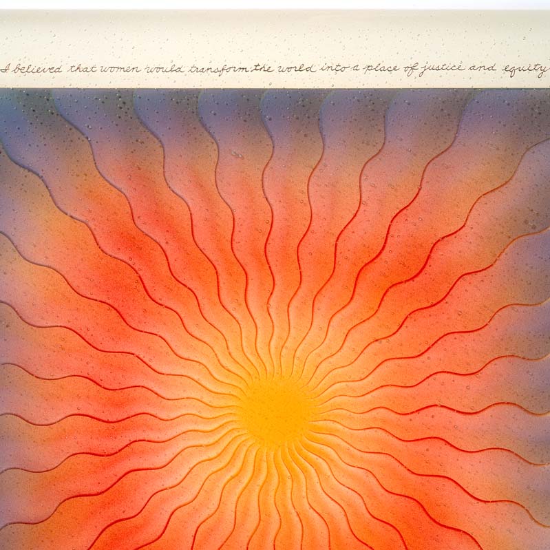 Painting of a sun-like form radiating out from the center in shades of yellow, red, and blue with handwriting around the edges