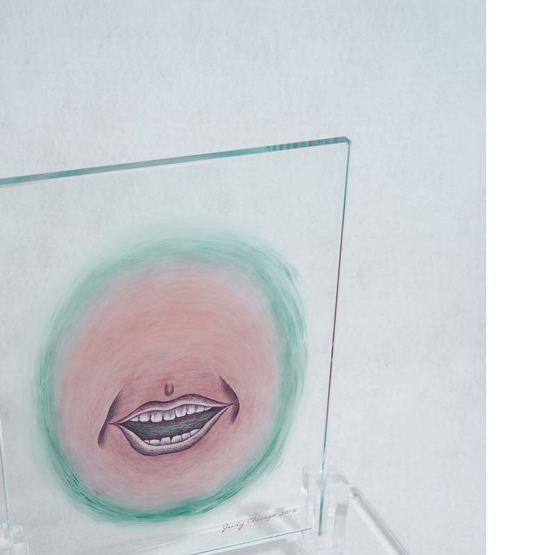 Pink and turquoise painting of an open mouth on a clear glass rectangle on a clear plinth