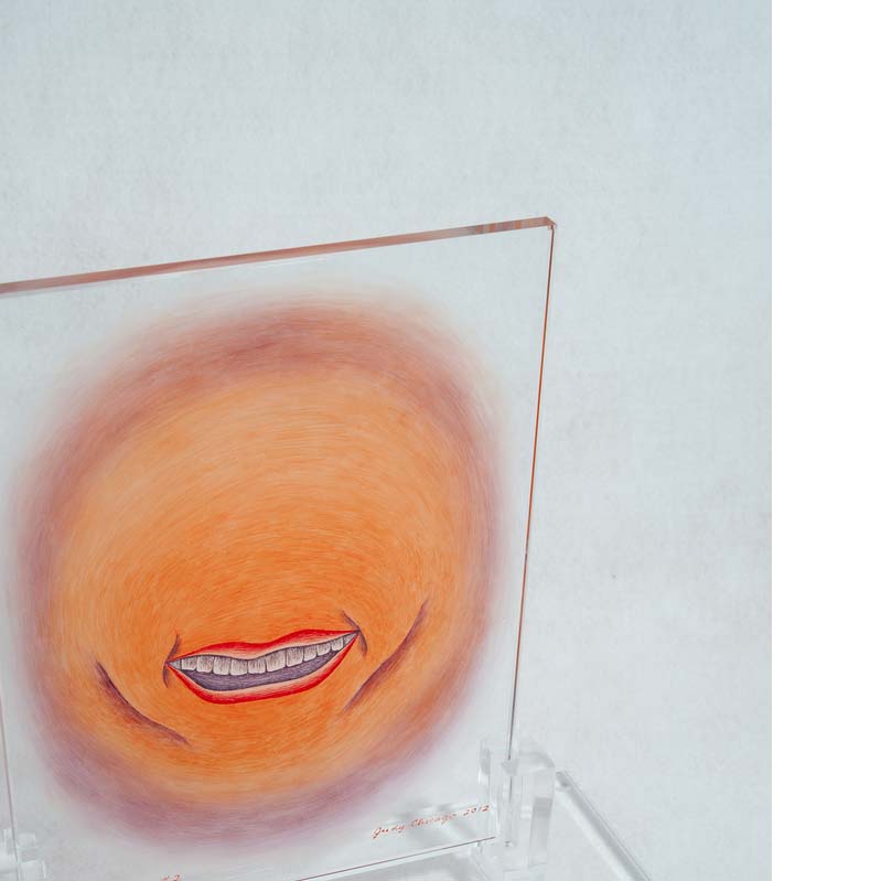 Orange, red, and brown painting of a smiling mouth on a clear glass rectangle on a clear plinth
