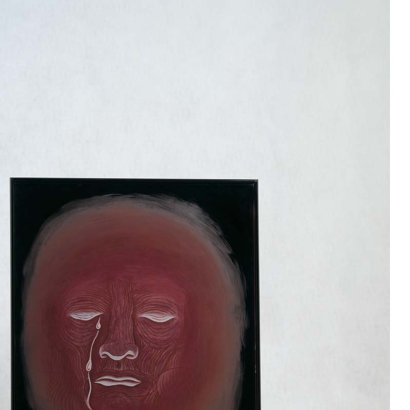Painting in shades of red of a crying face on a black glass rectangle on a clear plinth