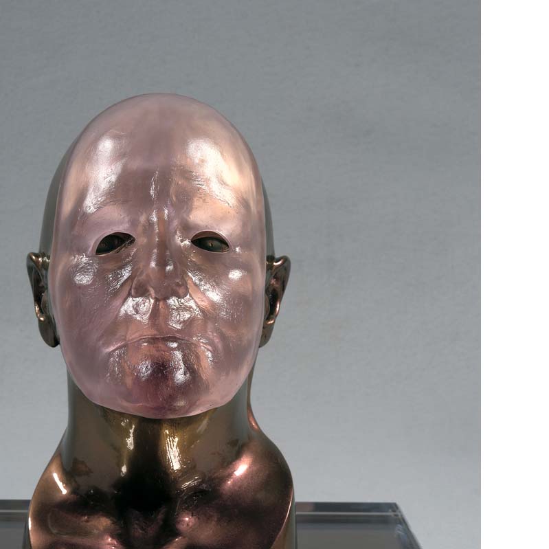 Shiny brown sculpture of a bald head wearing a translucent pink mask