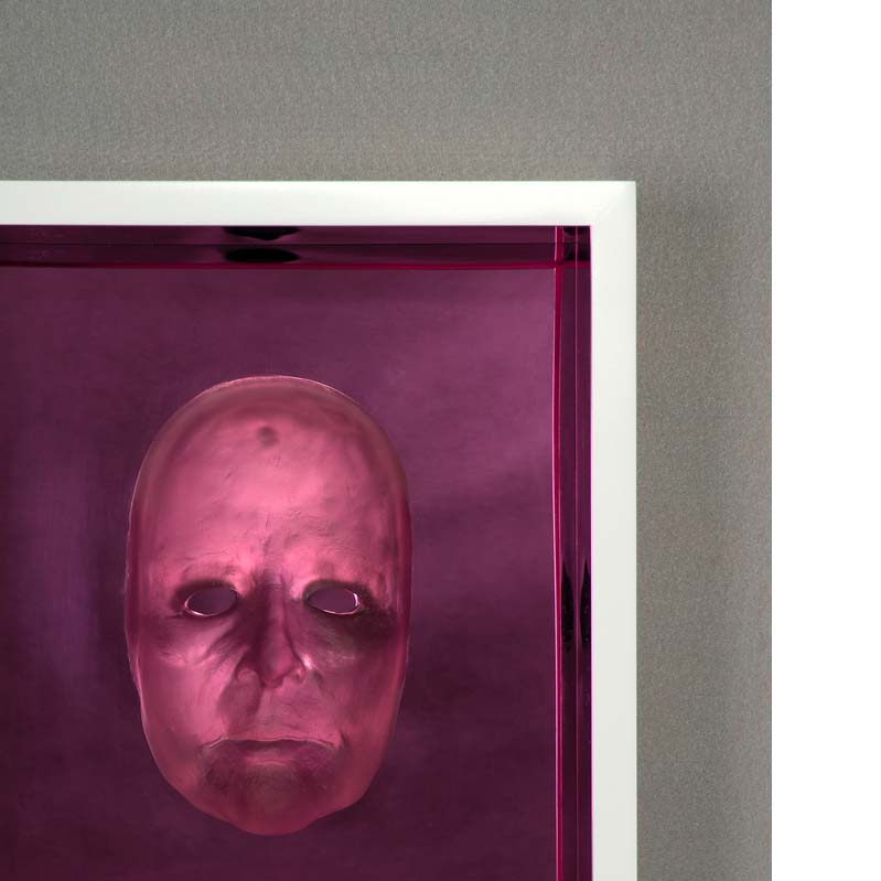 Translucent pink relief sculpture of a face framed on a purple background
