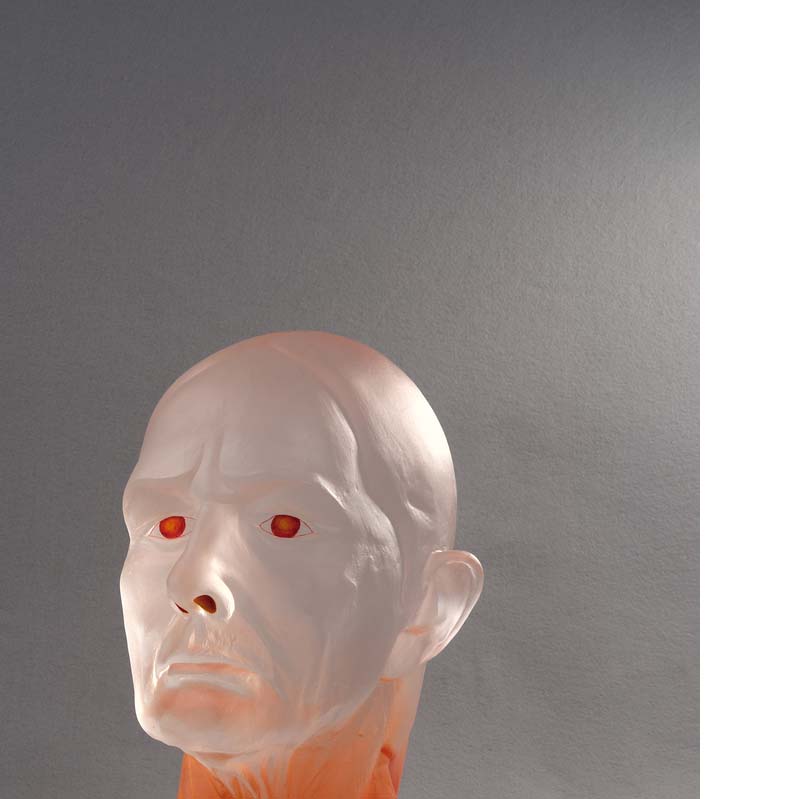 Translucent white and red sculpture of a bald head on a clear plinth