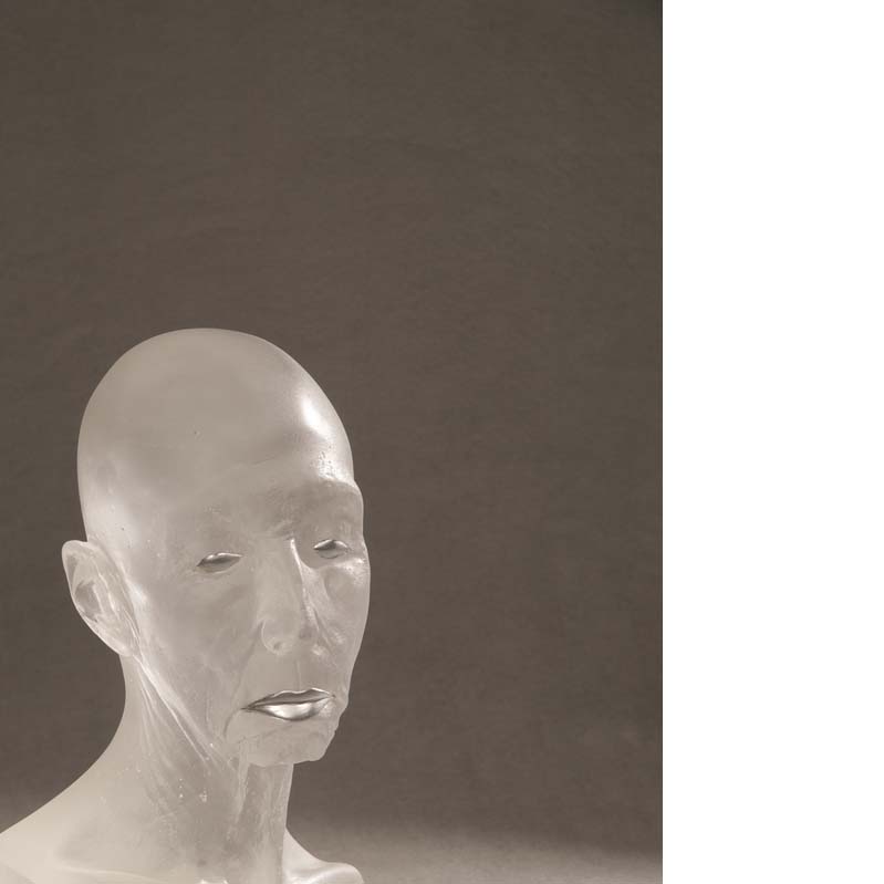 Translucent white sculpture of a bald head with silver eyes and mouth