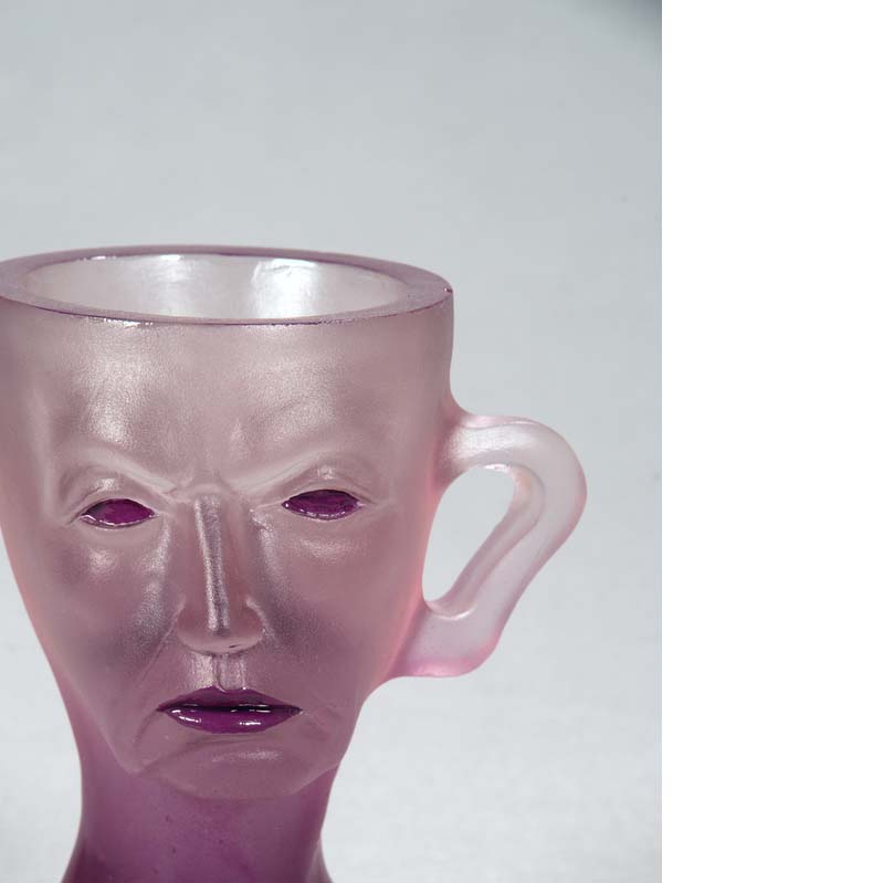 Mug in translucent purple with a face, handle, and a flared base