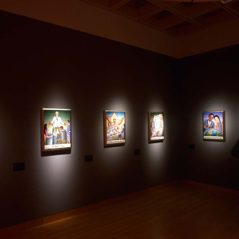 Color photograph of a person looking at six artworks arranged on two adjacent gray walls