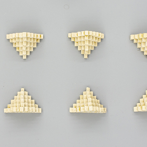 Nine yellow pyramids, seen from above, arranged in two rows with one at the end